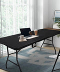 Foldable 6 Foot HDPE Table Go To Portable Banquet Surface Fold In Half Desk Utility For Working Meetings Parties Picnics Camping Weddings Catering Garden Dining Black set up in an office with chairs and laptop
