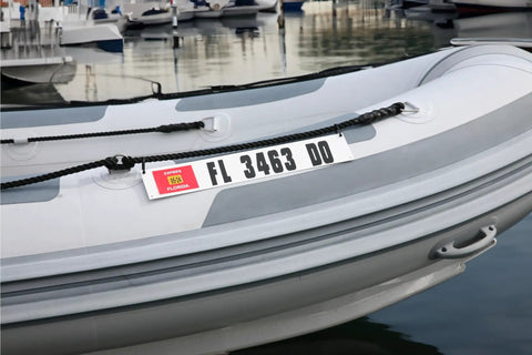 Marine Registration Plate Kit For Inflatable Boats And Ribs No Glue Needed 4 By 24 Inch ABS Mounting Boards With Zip Ties Saltwater Resistant Made In USA Pair displayed on an inflatable boat