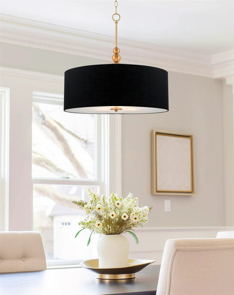 Adelade 23 Inch Modern 3 Light Drum Pendant Chandelier With Gray Fabric Shade And Glass Diffuser in a dining room setting.