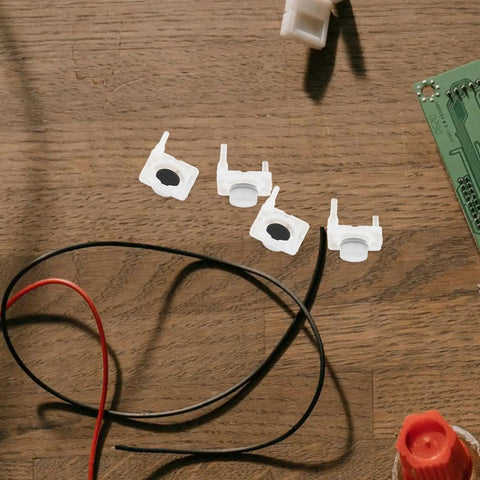 Four pieces of white silicone push button switches for easy installation in DIY repairs, part of 40 Piece Silicone Push Button Switch Replacement Keypad Membrane For Home Diy Repair And Emergency Stop Easy Install No Stress Swaps Big Time Durability For Worn Panels Knockout Quality Straight Up Reliable Setup That Simply Clicks In Perfectly.