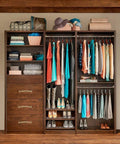 Walk-in closet with rustic barn door handles featuring vintage solid brass pulls in antique copper finish, cabinets and drawers.