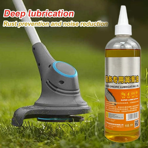 Bottle of friction-reducing chainsaw lubricant with deep rust protection placed on grass next to garden equipment.