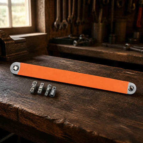 Badass Offset Extension Wrench With Swappable Drive Adapters And Quick Socket Attachments Built From Tough High Carbon Steel No Hustle Multi Tool For Cramped Spaces Or Gunked Up Bolts Orange on a workbench with adapters.