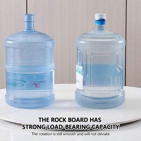 Polished Marble Lazy Susan Turntable with smooth rotation supporting large water bottles on a kitchen countertop.
