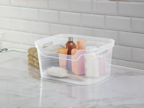 Solid As A Rock Clear Storage Bins Three Pack Tough As Nails Transparent Plastic Crates on countertop with toiletries