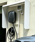 Heavy Duty Universal Ev Charger Cover Built Tough For Outdoor Rain Protection All Season Zero Sweat Weather Shield Galvanized Steel Guard attached above charging station.