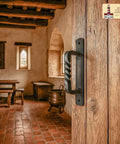 Premium Solid Heavy Duty Rustic Twisted Barn Door Handles In Black Wrought Iron six inch pull installed on a wooden door.