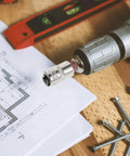 Heavy Duty Tamper Proof Hex Bit Sockets And Star Socket Set For Ratchet Wrenches on a drill beside blueprints and screws.