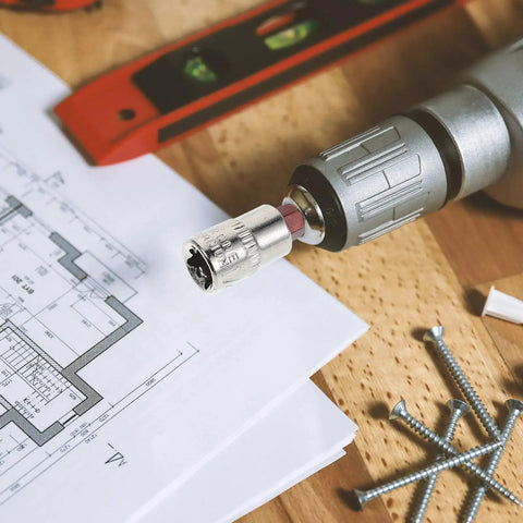 Heavy Duty Tamper Proof Hex Bit Sockets And Star Socket Set For Ratchet Wrenches on a drill beside blueprints and screws.