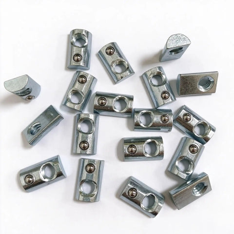 Heavy Duty Forty Pack Steel Spring Ball Roll In T Slot Nuts with Quarter Inch Twenty Thread from above on white surface.