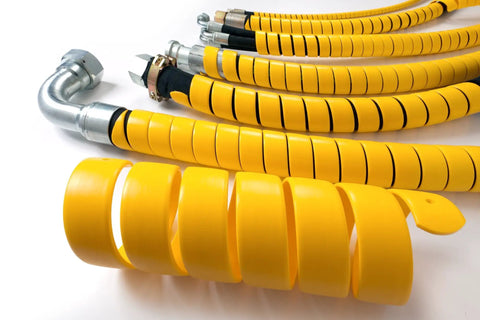 Close-up of Safe-Spiral Pre-Cut Spiral Wrap Hose and Cable Protector in Yellow HD-PE, 1.25 In OD, coiled next to protected hoses.