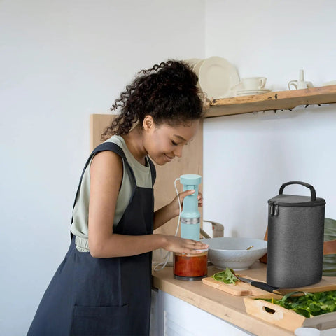 Custom Snug Storage Sleeve For KitchenAid Hand Blender KHBV53 Dishwasher Safe Arm Guard Holder With Jar Lid Pouch Sleek Grey beside user blending in kitchen.
