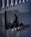 Industrial Grade 65mm Cnc Spindle Stabilizing Clamp Rack with accessories on a workbench, ideal for machinists and hobby shops.