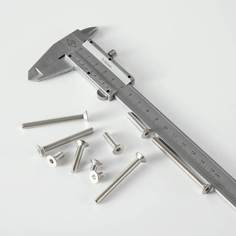 Heavy Duty M5 Flat Head Hex Socket Countersunk Screws Assorted Lengths Twenty To Forty Millimeters next to a caliper for measurement.