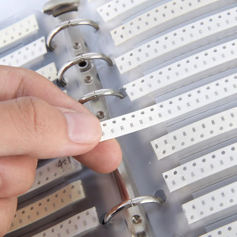SMD 0603 Capacitor Kit Serving A Badass 2250 Piece Ceramic Chip Assortment showing labeled compartments in a folder.