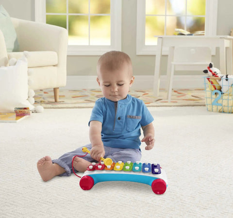 Toddler exploring Super Fun Musical Xylophone Pull Toy for Toddlers and Kiddos, Includes Mallet and 8 Colorful Keys.