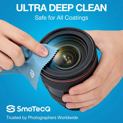 SmoTecQ Glasses Cleaner Kit with two 2oz spray bottles and two microfiber cloths being used to clean a camera lens