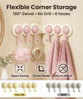 Game Changer Adhesive Corner Hooks With Smooth 180 Degree Rotation Foldable Rack displaying six pink hooks for towels in a bathroom.