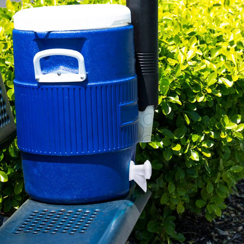 Blue cooler with push button spigot installed outdoors, showcasing Push Button Cooler Spigot Replacement 3 Pack White For 2 To 10 Gallon Beverage Coolers Durable Water Dispenser Spigots Ideal For Outdoor Parties And Home Use.