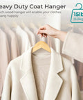 Ten Pack Heavy Duty Solid Birch Wood Coat Hangers With 360 Degree Swivel Hooks And Pant Bar For Jackets Dresses Shirts Natural Wood Suit Hangers For Closet Organization holding a white coat