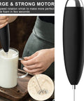 Handheld Electric Milk Frother Wand for Coffee at Home, Battery Operated Drink Mixer in use with milk jug on countertop