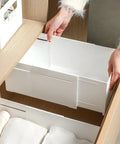 Slick Adjustable Drawer Organizer Slides Easy To Block Any Gap No Sweat Guaranteed For Organizing Makeup Pens And Gear In Kitchen Drawers Or Office Setups in a wooden cabinet with white drawer.