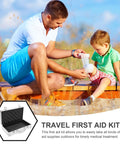 Man using a Travel First Aid Kit to bandage a child's knee outdoors on a sunny day.