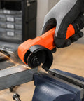 Close-up of Workhorse Heavy Duty Handheld Angle Grinder cutting steel with sparks flying, ideal for tight corners.
