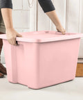 Person lifting a Pink 18 Gallon Storage Bin With Secure Snap On Lid Heavy Duty Stackable Plastic Tote Clutch.