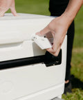 MaxCold Glide 110 Qt Insulated Rolling Cooler latch detail with hands showing lockable leak-proof design feature