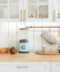 2 Pack Solid Brass Gold Cabinet Pulls with 3 and 3 Quarters Inch Center to Center on kitchen cabinets above a wooden countertop.