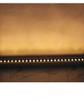 Heavy Duty Dimmable Led Wall Washer Floodlight Featuring Rock Solid Aluminum Build And Scratch Proof Glass For Stunning Indoor Outdoor Lighting And Lowkey Epic Studio Vibes illuminating a wall with soft yellow light.