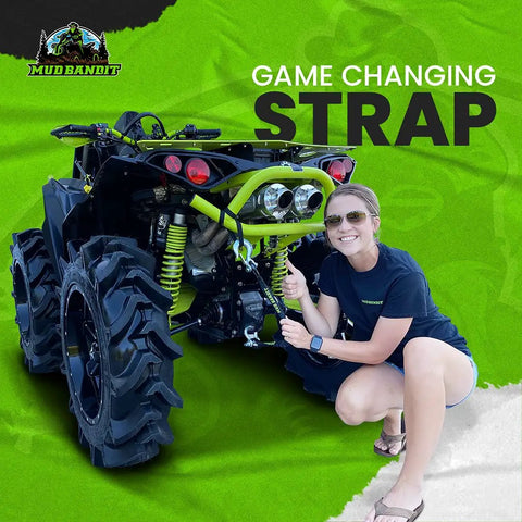 Woman attaching Two Foot ATV Recovery Strap With Winch Hook And D Ring Shackle For Four Wheelers And Quads 17600 Pound Synthetic Rope to quad.