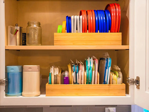 Bamboo Kitchen Lids Organizer With Adjustable Dividers for Food Storage Containers up to 9.5 Inches arranged in a kitchen cabinet