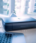 OfficeJet 250 Wireless Mobile Printer Scanner Copier With Battery Included All In One On The Go Portable Printer shown on a desk next to a laptop.