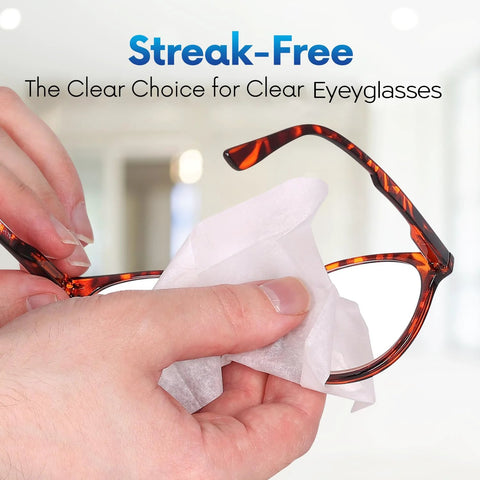 Eyeglass lens wipe; close-up of hand cleaning tortoiseshell eyeglasses with a white wipe