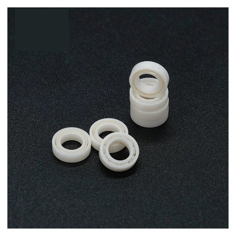 Top Shelf Rock Solid Full Ceramic ZrO2 MR74 Sealed Ball Bearing 4X7X2.5MM, showing white ceramic bearings stacked and arranged.