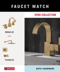 Champagne bronze faucet and fixture set on gray counter from Vero Collection, highlighting modern bath hardware design.