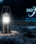 Portable LED Camping Lantern 2-Pack With Battery Operated Lights showing 360-degree illumination on a rock at night.