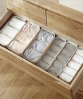 3 Piece Stackable Storage Box Set With Dividers For Bras And Leggings Multi Compartment Drawer Organizer Bin For Underwear Socks Plus Neck Ties organized with socks and leggings in a neat drawer.