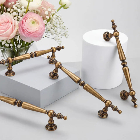 Solid Antique Brass Cabinet Pulls 5 Inch Drawer Handles 5 Pack Vintage Zinc Alloy Furniture Hardware on display with flowers.