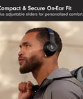 Solo 4 Wireless Bluetooth On-Ear Headphones Serving Serious Heat And 50-Hour Battery Life For Your Daily Ride Built With Ultra Lightweight Flex-Grip Cushions And Immersive Spatial Audio Technology In Matte Black worn by a man with adjustable sliders for fit.