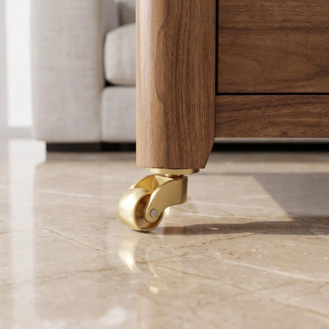 Close-up of 4-Pack Brass Heavy Duty Furniture Casters gliding smoothly on a marble floor, showcasing swivel capability.