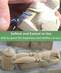 Close-up of unfinished basswood carving blocks with a person whittling, showing detail and use for DIY projects and arts.