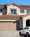 Garage with Heavy Duty Garage Door Hardware Kit with Solid Steel Door Handle Hinges visible on a two-car tan door.