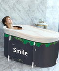 Person relaxing in Foldable Portable Bathtub For Small Bathrooms And Shower Stalls Eco Friendly Soaking Tub With Thermal Foam Keeps Water Warm No Fuss Setup Thick Insulation Easy Drain Whale Blue