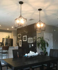 Dope Three Light Industrial Farmhouse Chandelier In Matte Black With Square Cage Pendant above dining table in kitchen