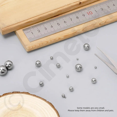 Heavy Duty Loose Bicycle Bearing Balls Assortment Kit With 300 Precision Steel Replacement Balls Across 12 Ready To Roll Sizes, steel balls on workspace.