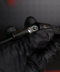 Close-up of Flexible Socket Extension Set for 1/4 and 3/8 Inch Drive held in black gloved hand, highlighting metal connector.