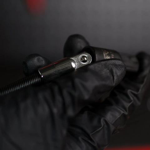 Close-up of Flexible Socket Extension Set for 1/4 and 3/8 Inch Drive held in black gloved hand, highlighting metal connector.